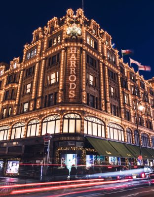 LONDON - DECEMBER 18, 2019: Harrods London department store shop at night with lights